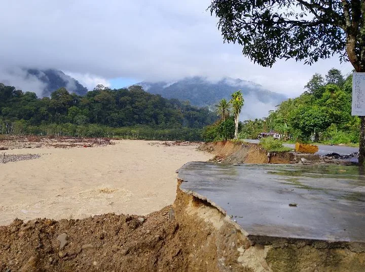Most of the road is taken up by the river after catastrophic Sumatra floods.